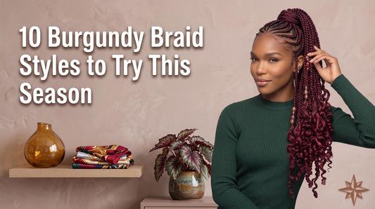 A woman wearing a green sweater featuring high ponytail burgundy braids adorned with gold beads, next to a shelf with stacked silk scarves and a potted begonia.