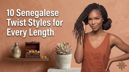 A woman in an orange top touching her shoulder-length Senegalese twists near a wooden box filled with gold hair cuffs.