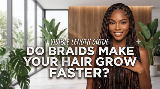 A smiling woman with long brown-highlighted box braids touching her hair, standing in a brightly lit room with indoor plants.