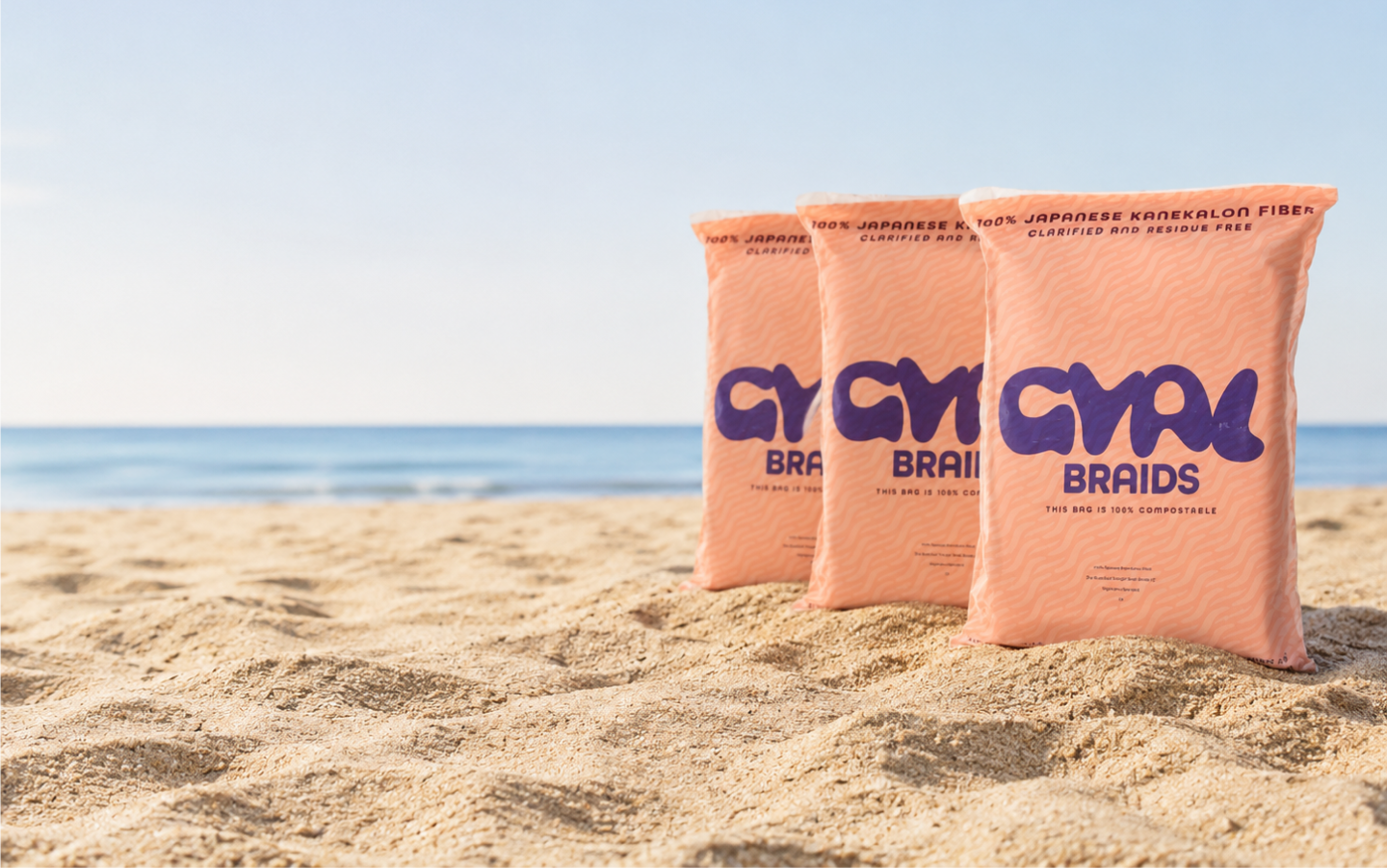 Gyal Braids packs half-buried in beach sand